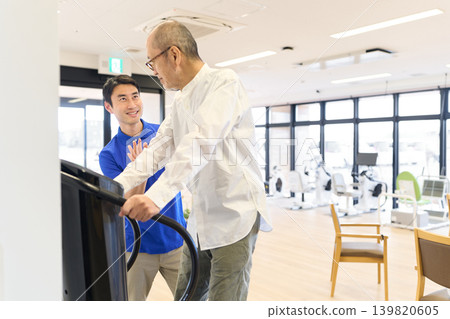 Seniors and caregivers undergo rehabilitation using a vibration training machine. Seniors and caregivers undergo rehabilitation using a vibration training machine. 139820605