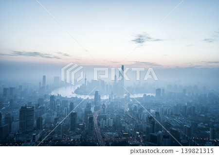 A panoramic aerial view of the skyscrapers of Shanghai's Lujiazui district and the Huangpu River, enveloped in morning mist and silence. A panoramic aerial view of the skyscrapers of Shanghai's Lujiazui district and the Huangpu River, enveloped in morning mist and silence. 139821315