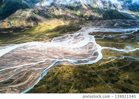 A vertical aerial view of the mystical network of river channels (branched rivers) carved across the wilderness by the meltwater of the Laigu Glacier in Tibet. A vertical aerial view of the mystical network of river channels (branched rivers) carved across the wilderness by the meltwater of the Laigu Glacier in Tibet. 139821340