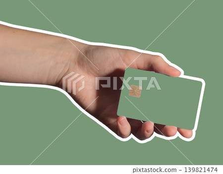 Hand holding green bank card for cashless payment. Hand holding green bank card for cashless payment. 139821474