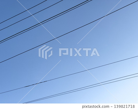 High voltage electricity transmission line against blue sky. Power energy network and technology. 139821718