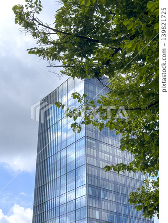 Modern building with green tree elements and glass facades. Eco friendly architecture concept Modern building with green tree elements and glass facades. Eco friendly architecture concept 139821725