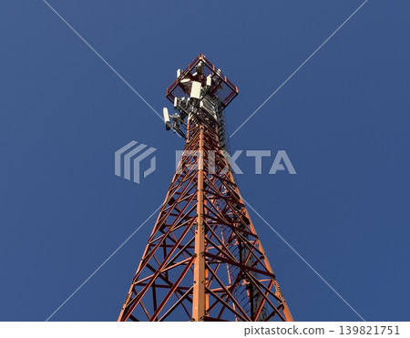 Telecom tower with antennae against blue sky. Wireless mobile communication network showing radio 139821751