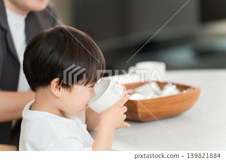 A child's profile as they drink juice and rehydrate during snack time. A child's profile as they drink juice and rehydrate during snack time. 139821884