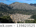 A mountain town viewed from a nearby mountain. 139823525