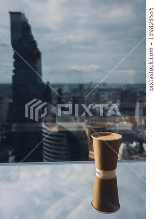 takeaway coffee cup on rooftop with modern Bangkok skyline and skyscraper view, cappuccino espresso on panoramic city terrace with urban highrise architecture background takeaway coffee cup on rooftop with modern Bangkok skyline and skyscraper view, cappuccino espresso on panoramic city terrace with urban highrise architecture background 139823535