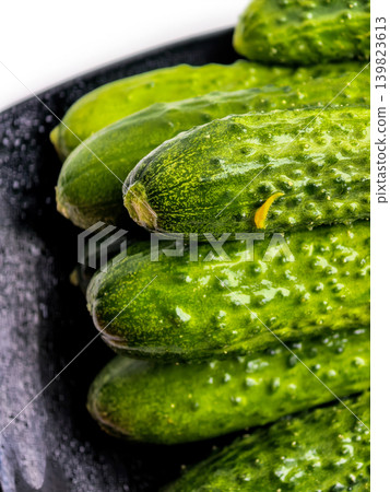 Fresh Green Cucumbers On Black Plate Fresh Green Cucumbers On Black Plate 139823613