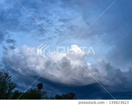 Towering Storm Clouds Above Landscape At Dusk Towering Storm Clouds Above Landscape At Dusk 139823623