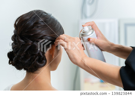 A woman applying makeup A woman applying makeup 139823844