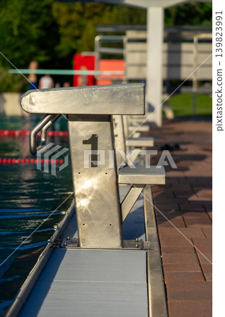 View of the starting blocks in the outdoor pool on a summer evening 139823991