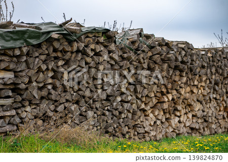 Harvested firewood for the stove and fireplace, stacked on top of each other Harvested firewood for the stove and fireplace, stacked on top of each other 139824870