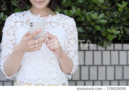 Woman operating an app Woman operating an app 139826090