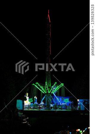 Tall illuminated swings ride at the County Fair operates at night Tall illuminated swings ride at the County Fair operates at night 139826328