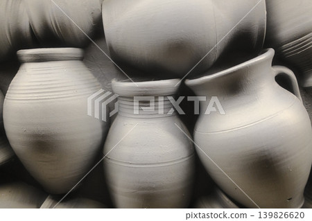 Several gray clay vases and jugs are arranged close together Several gray clay vases and jugs are arranged close together 139826620