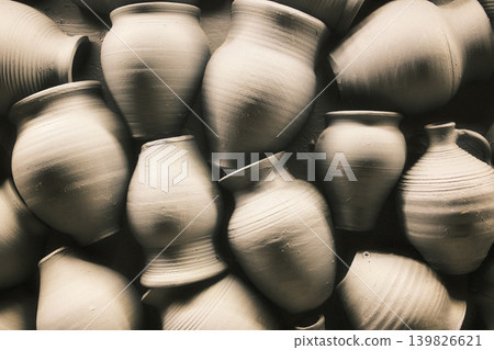 Many handmade pots and jugs of different shapes and sizes are grouped together Many handmade pots and jugs of different shapes and sizes are grouped together 139826621