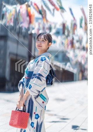 A Japanese woman in a yukata walks through a retro townscape: A Japanese-style portrait, a summer memory. A Japanese woman in a yukata walks through a retro townscape: A Japanese-style portrait, a summer memory. 139826648