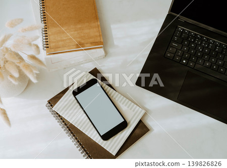 Workspace flat lay with laptop, smartphone and notebooks on a white desk Workspace flat lay with laptop, smartphone and notebooks on a white desk 139826826