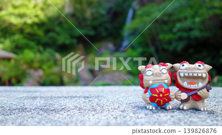 Okinawan scenery and smiling Shisa, sanshin (Okinawan stringed instrument), flower hat, copy space, Todoroki Falls 139826876