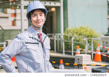 A site supervisor standing at a construction site 139826924