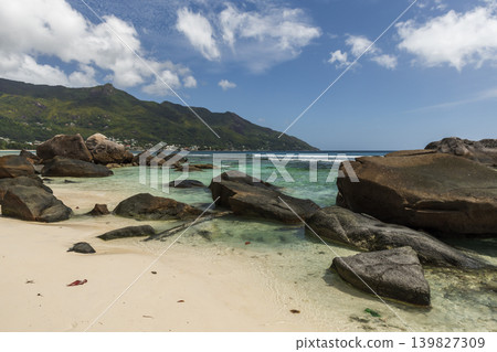 Coastal view with clear turquoise water, black rocks and blue sky creates a scenic view Coastal view with clear turquoise water, black rocks and blue sky creates a scenic view 139827309