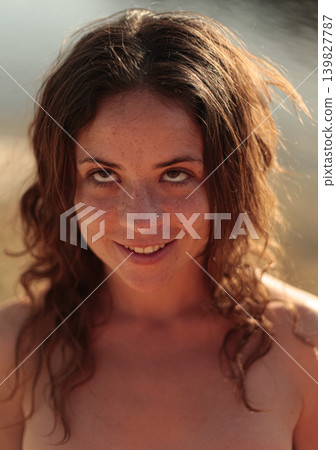Carefree woman enjoying peaceful sunset scenery near a wetland Carefree woman enjoying peaceful sunset scenery near a wetland 139827787