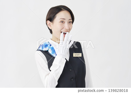 A smiling, surprised female staff member (receptionist/bus guide) against a white background. A smiling, surprised female staff member (receptionist/bus guide) against a white background. 139828018