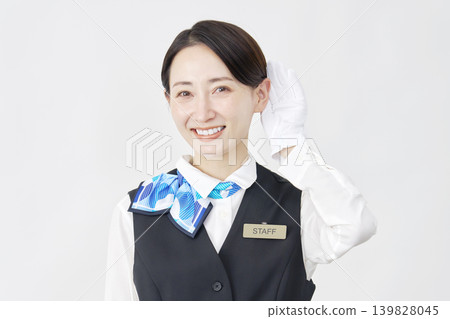 Female staff member, receptionist/bus guide, listening gesture, white background. Female staff member, receptionist/bus guide, listening gesture, white background. 139828045
