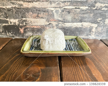 Shio Mame Daifuku is a type of Japanese confectionery. It consists of slightly salty beans and sweet bean paste wrapped in mochi rice cake. 139828339