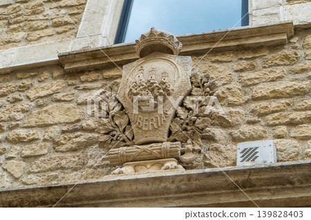 San Marino stone coat of arms with three towers and Libertas text on historical building facade San Marino stone coat of arms with three towers and Libertas text on historical building facade 139828403