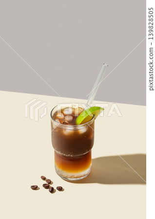 Cold Coffee Tonic Drink With Lime and Ice on light background with shadows 139828505