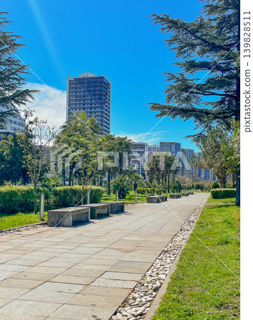 Green city park with trees and modern residential buildings, urban nature and sustainable concept Green city park with trees and modern residential buildings, urban nature and sustainable concept 139828511