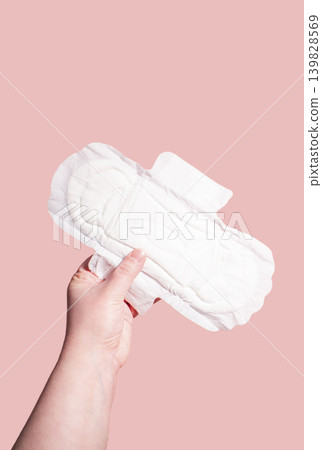 White sanitary pads in hand. Concept of menstruation, ovulation, reproduction, pain and personal feminine hygiene 139828569