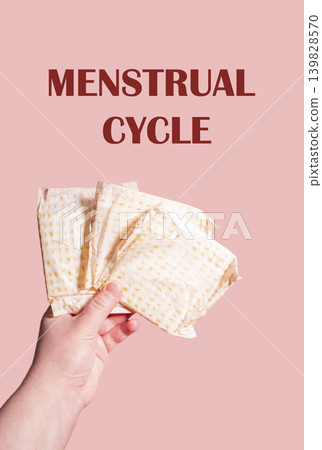 Classic menstrual pads in woman hand. Menstrual cycle and suffering from menstrual pain. Female period and intimate hygiene Classic menstrual pads in woman hand. Menstrual cycle and suffering from menstrual pain. Female period and intimate hygiene 139828570