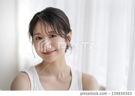 A young woman smiling at camera A young woman smiling at camera 139830383