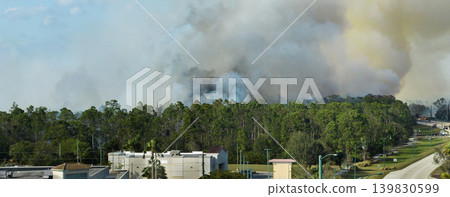 Aerial view of strong wildfire burning severely in North Port city, Florida. Natural disaster during dry season in jungle woods Aerial view of strong wildfire burning severely in North Port city, Florida. Natural disaster during dry season in jungle woods 139830599