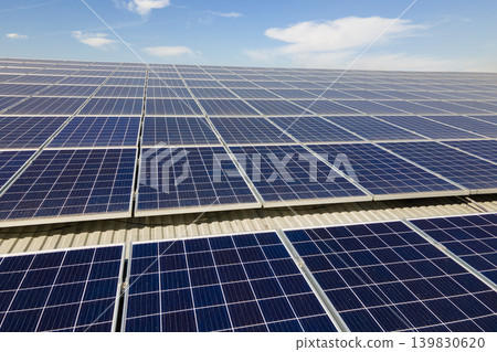 Solar photovoltaic panels installed on building roof for producing clean ecological electric energy. Renewable electricity with zero emission concept 139830620