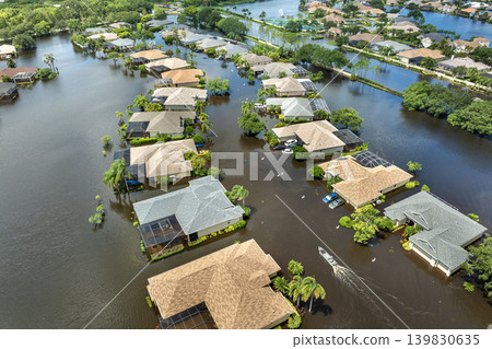 Hurricane Debby flooded street in Sarasota, Florida. Victims boating on rainfall flood waters between rural homes in residential area Hurricane Debby flooded street in Sarasota, Florida. Victims boating on rainfall flood waters between rural homes in residential area 139830635
