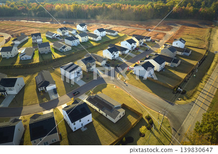 View from above of densely built residential houses in living area in South Carolina. American dream homes as example of real estate development in US suburbs View from above of densely built residential houses in living area in South Carolina. American dream homes as example of real estate development in US suburbs 139830647