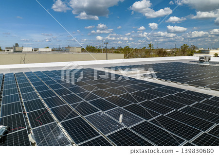 Photovoltaic solar panels destroyed by hurricane strong wind mounted on industrial building roof for producing green ecological electricity. Consequences of natural disaster in Florida Photovoltaic solar panels destroyed by hurricane strong wind mounted on industrial building roof for producing green ecological electricity. Consequences of natural disaster in Florida 139830680