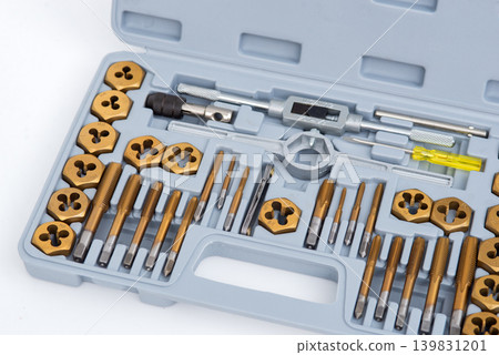 Professional tap and die set with titanium-coated thread cutting tools organized in a gray plastic case. Professional tap and die set with titanium-coated thread cutting tools organized in a gray plastic case. 139831201