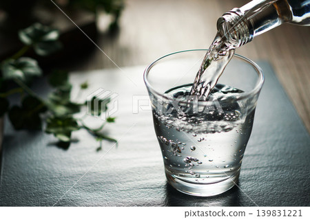 Mineral water being poured into a glass 139831221