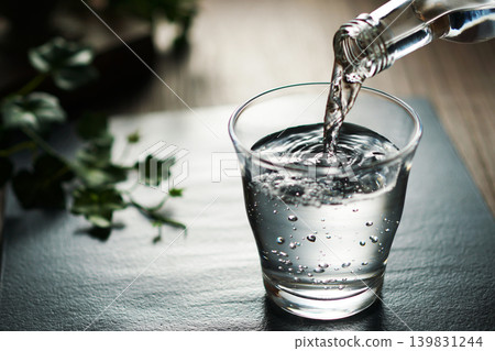 Mineral water being poured into a glass Mineral water being poured into a glass 139831244