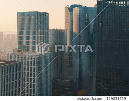 Downtown buildings and skyscrapers in Hangzhou at early evening, sunlight reflecting off windows, showing modern architecture Downtown buildings and skyscrapers in Hangzhou at early evening, sunlight reflecting off windows, showing modern architecture 139831759