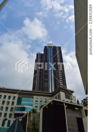 Low angle view of skyscapers of Hong Kong. Hong Kong cityscape. Modern Buildings. Building exterior. Travel concept. Low angle view of skyscapers of Hong Kong. Hong Kong cityscape. Modern Buildings. Building exterior. Travel concept. 139831884