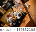 A Japanese-style interior featuring a beckoning cat and a glass sake bottle, evoking Japanese culture. 139832108