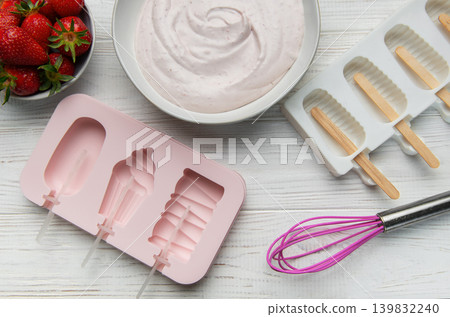 Preparing homemade strawberry ice cream popsicles Preparing homemade strawberry ice cream popsicles 139832240