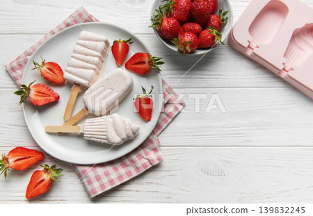 Homemade strawberry popsicles with fresh fruit on white wood Homemade strawberry popsicles with fresh fruit on white wood 139832245