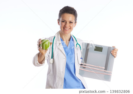 Female Doctor Holding Green Apple and Weight Scale Female Doctor Holding Green Apple and Weight Scale 139832806