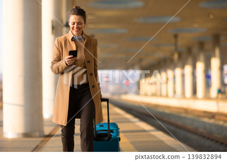 Female Traveler Navigating Train Station with Smartphone Female Traveler Navigating Train Station with Smartphone 139832894