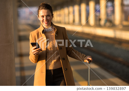 Confident Business Woman with Suitcase at Railway Station Confident Business Woman with Suitcase at Railway Station 139832897
